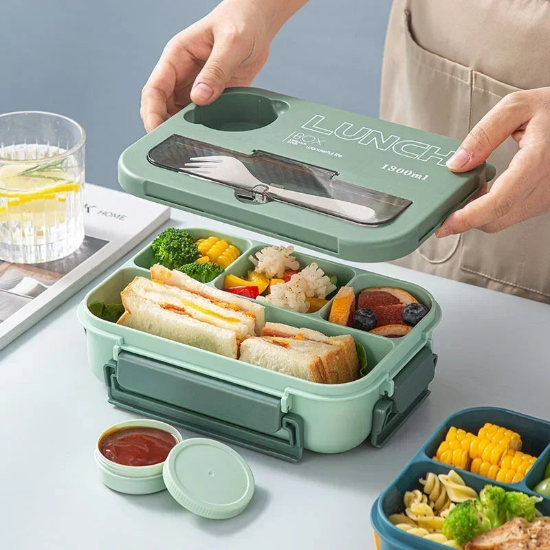 Student and office worker-friendly compartmentalized lunch box with fork and spoon, suitable for microwave use